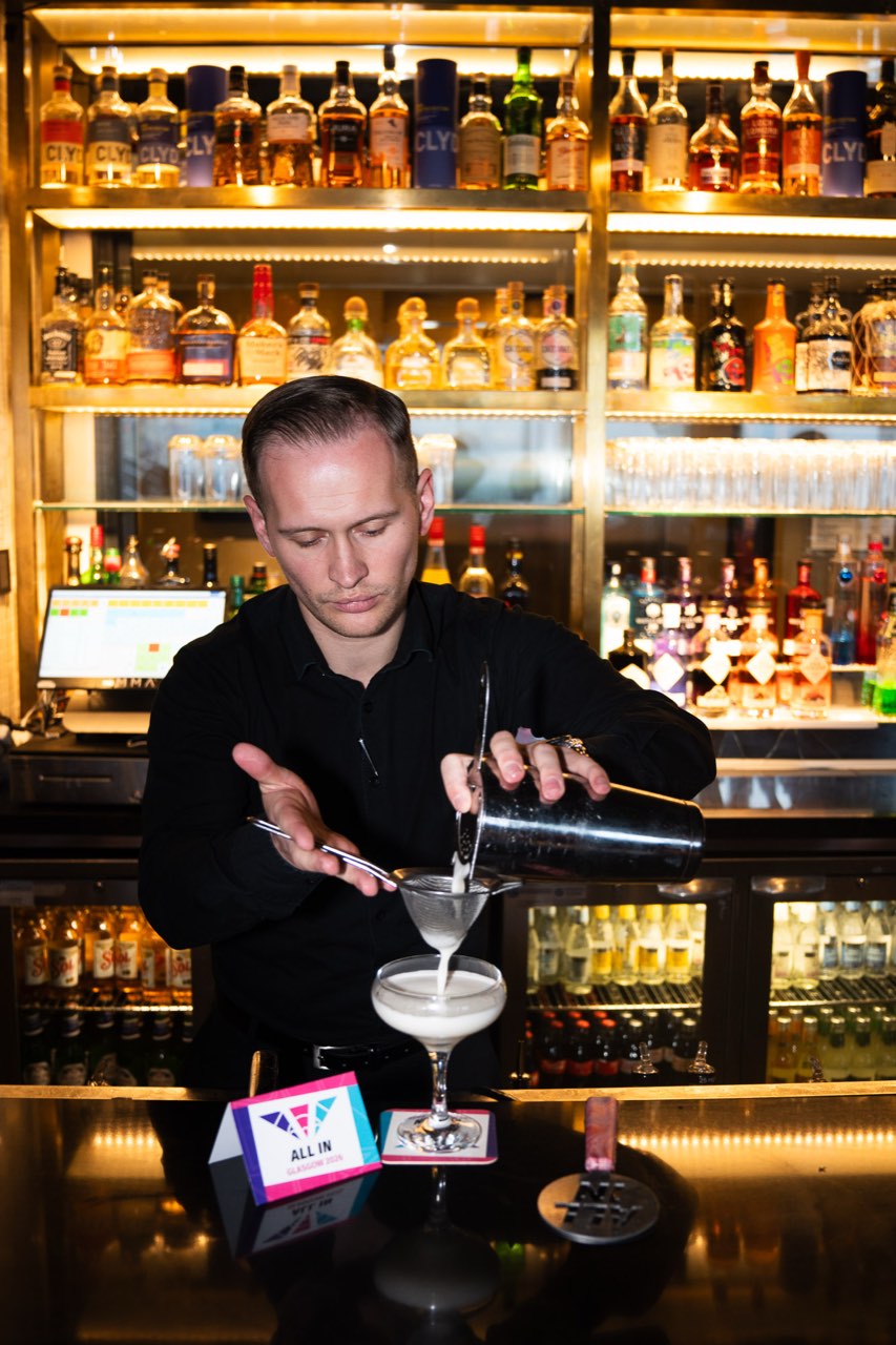 A bartender preparing an All In stencilled cocktail