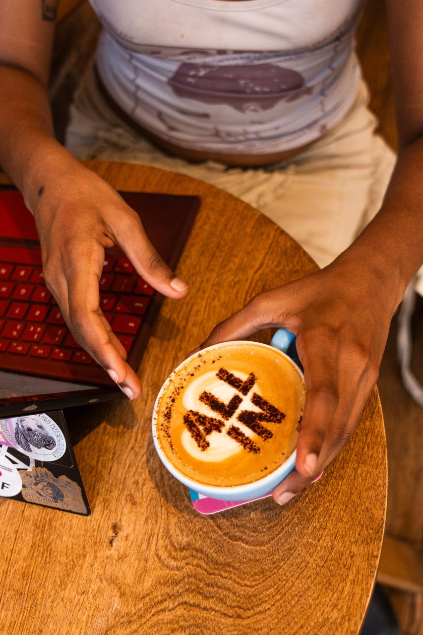 Friends enjoying an All In stencilled coffee in a Glasgow café